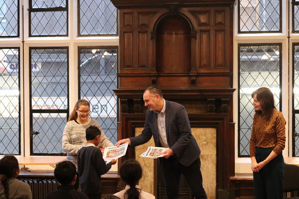 CEO Jim Minton hands out certificates to Canon Barnett Primary School pupils