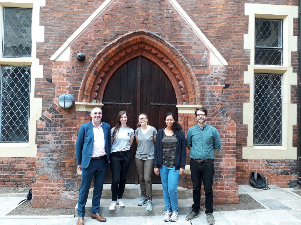 Residential voluntary workers with Jim Minton outside the doors to our halls